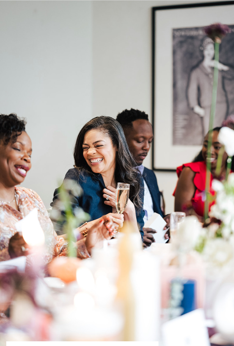 Guests laughing together at Erica's Table of 20