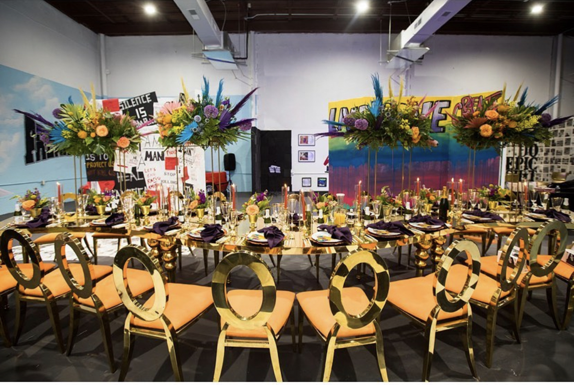 A complete Table of 20 tablescape with florals and gold seating