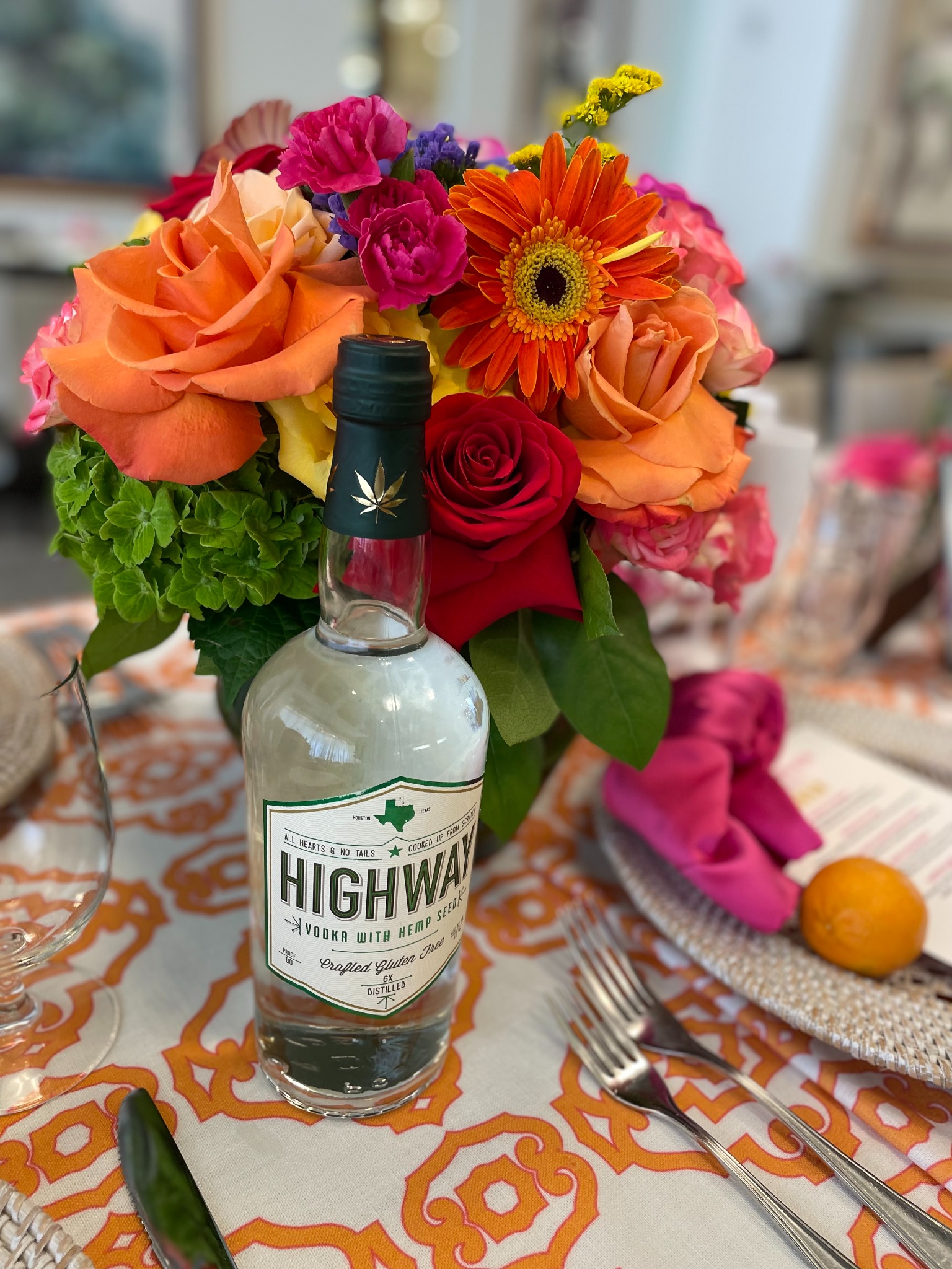 Vibrant florals and a beverage partner woven into the tablescape