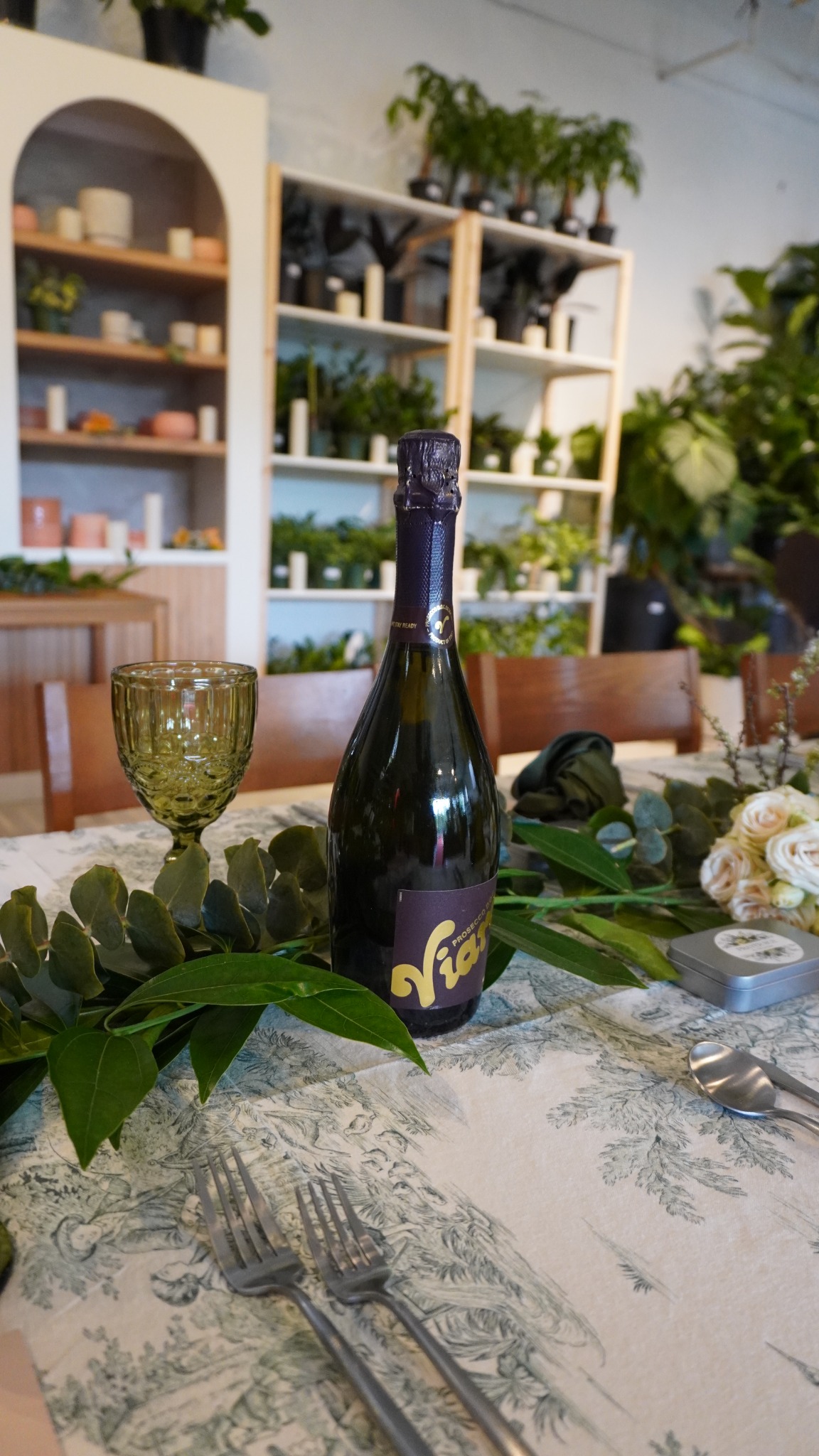 Prosecco presented within an intimate green tablescape