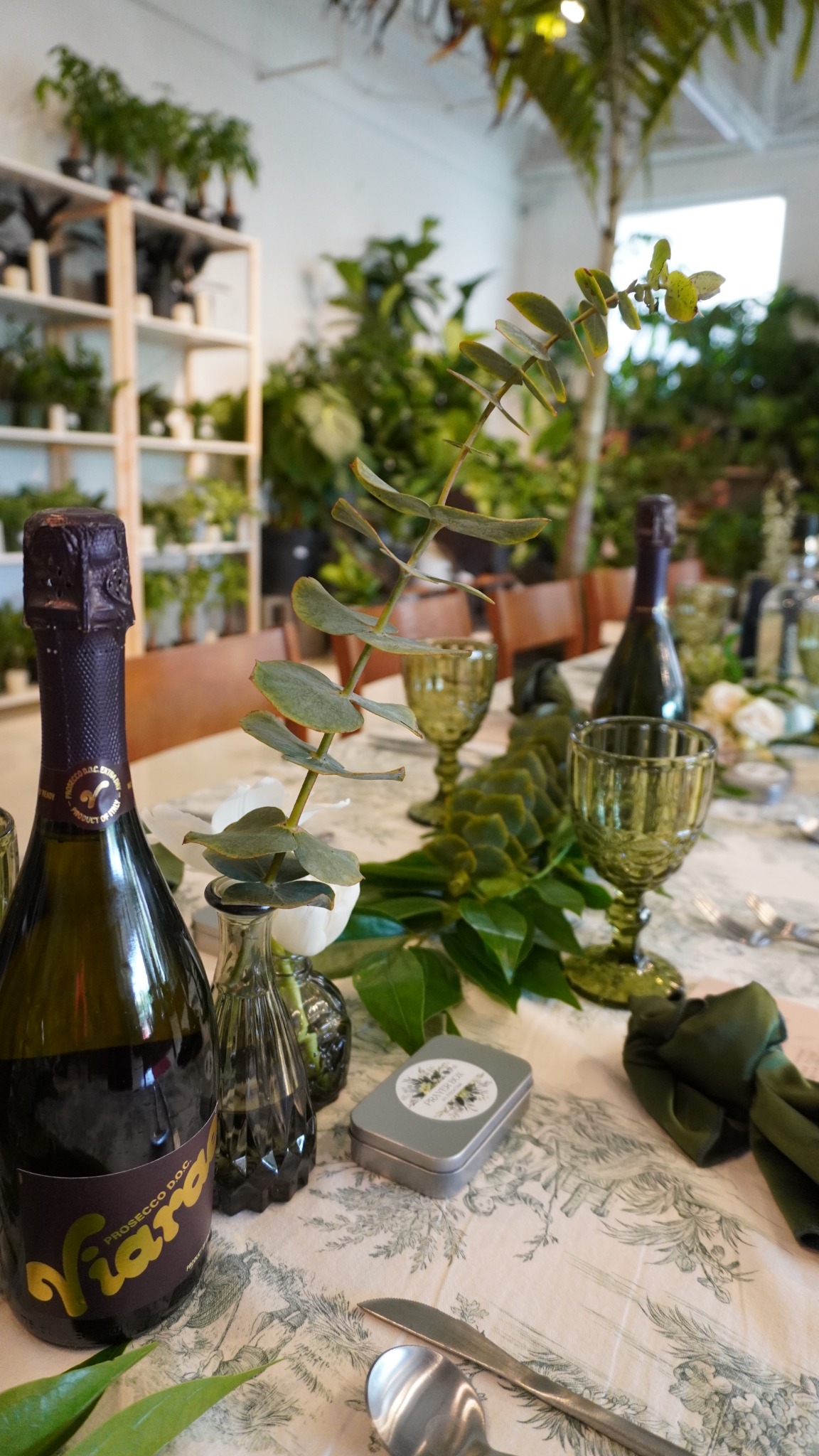 Editorial table detail with greenery and glassware